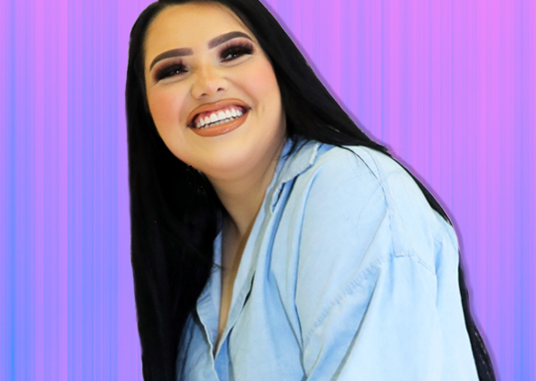 YouTube creator Karina Garcia wearing a jean jacket with a blue and pink background