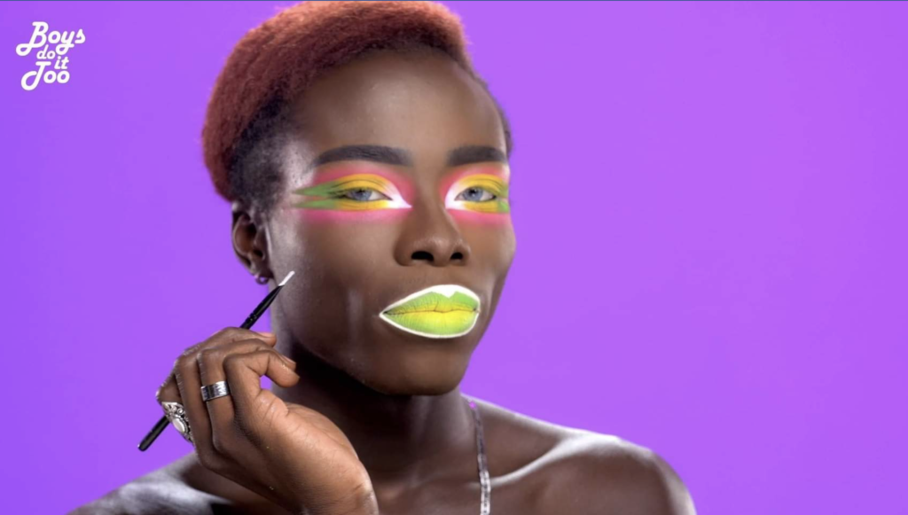 And Boys Do It Too, LGBTQ+ Creators spotlight feature. Person against a purple background with dramatic makeup