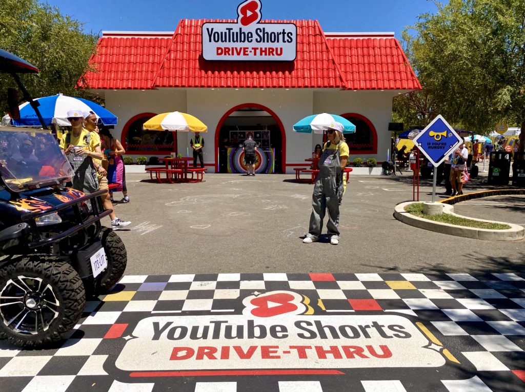 Exterior image of a YouTube Shorts branded fast food restaurant with a red roof. 