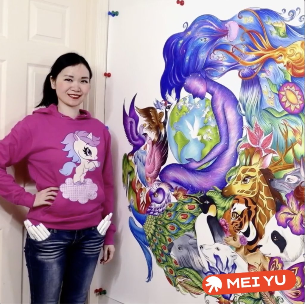 Creator Mei Yu stands next to one of her artworks