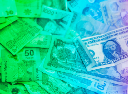 Pile of global currencies with transparent rainbow overlay