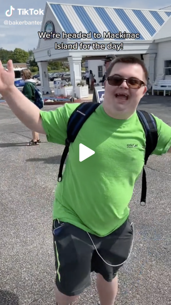 Creator bakerbanter wearing green shirt outside excited to head to Mackinac Island for the day