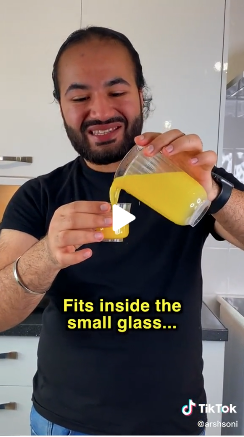 Creator Arshdeep Soni smiling as he pours a large glass of orange juice into a smaller glass 