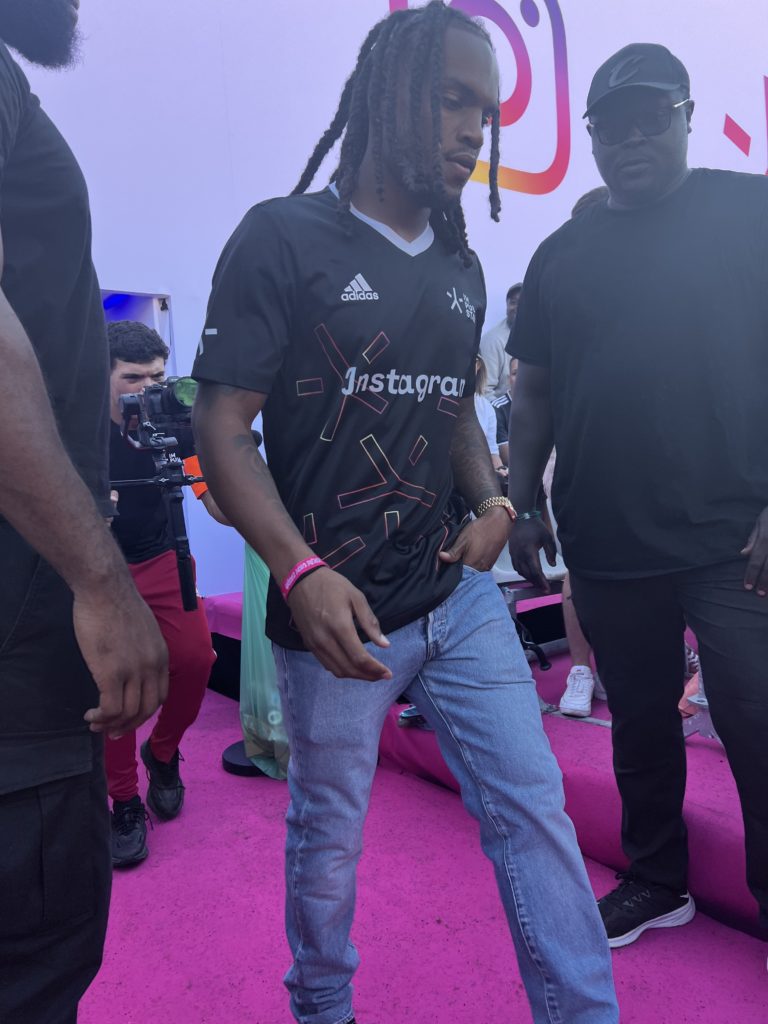 Candid of Renato Sanches, Paris Saint-Germain player, walking through a group of people.