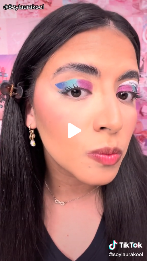 Creator SoyLauraKool pursing lips wearing colorful blue, teal and pink eyeshadow 