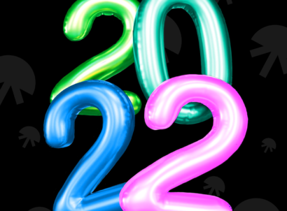2022 balloons in green, teal, blue, and pink on a black background.