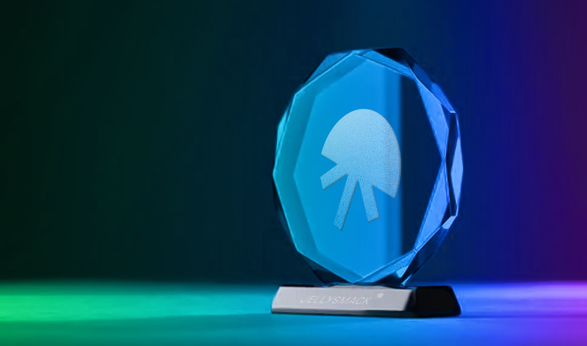 Glass award with Jellysmack jellyfish logo lit with blue and green shadows.