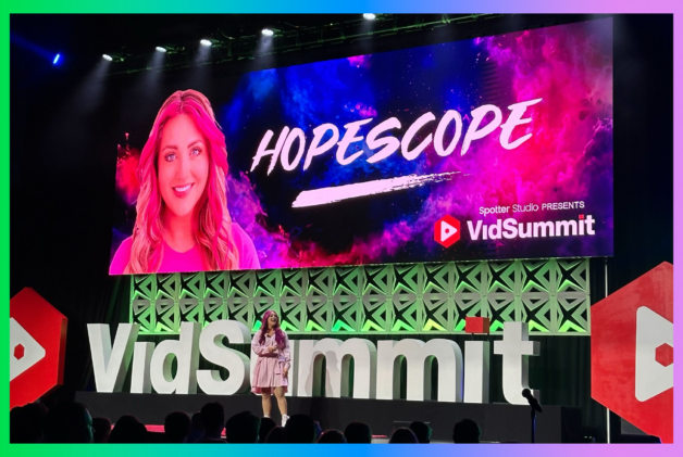 Creator HopeScope on stage in front of VidSummit sign speaking at a conference